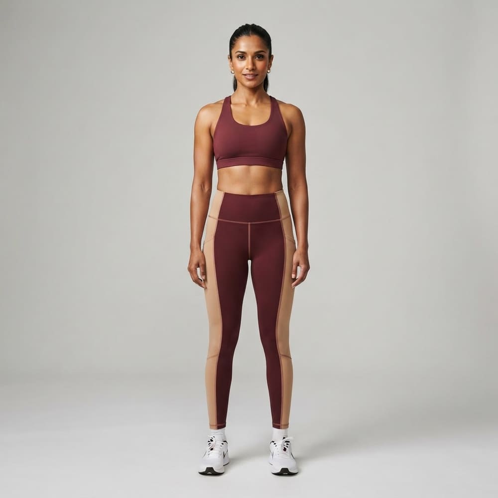 Indian woman wearing META NEST ACTIVEWEAR Duality Colour-Block Leggings in Maroon Beige
