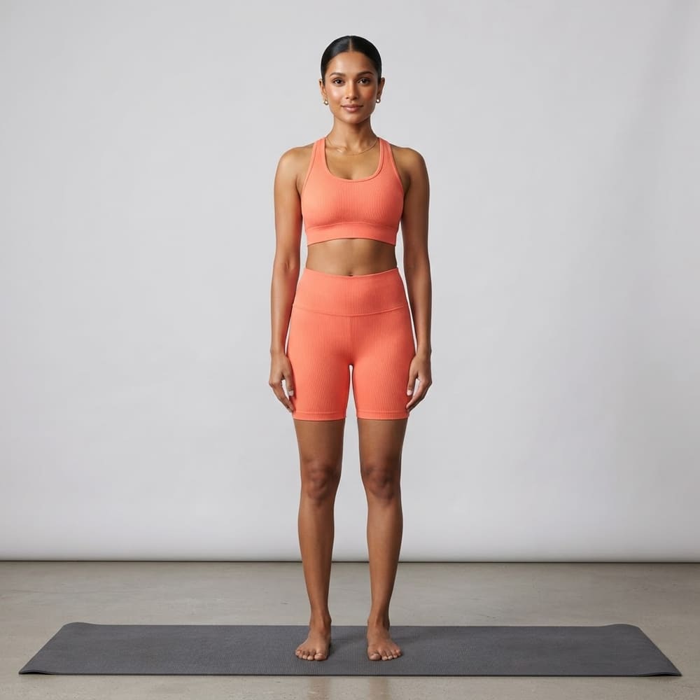 Indian woman wearing META NEST ACTIVEWEAR Pulse Ribbed Racerback Bra in Sunset Coral